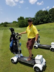 Man riding electric golf cart